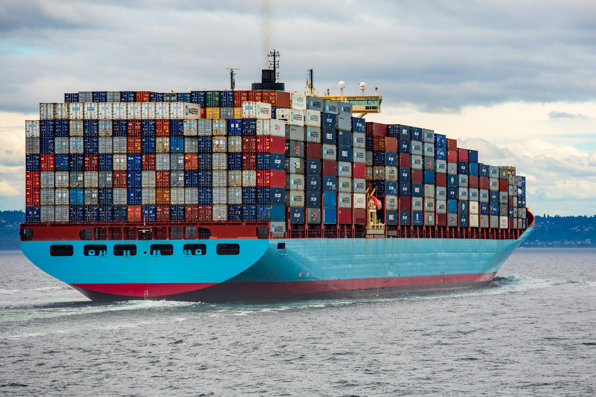 Container ship under way at sea, fully loaded with export cargo